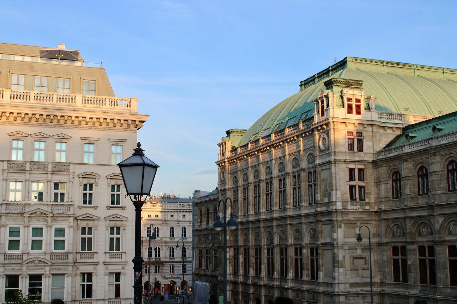 Beautiful historic buildings with classic architecture under a clear blue sky in Vienna.