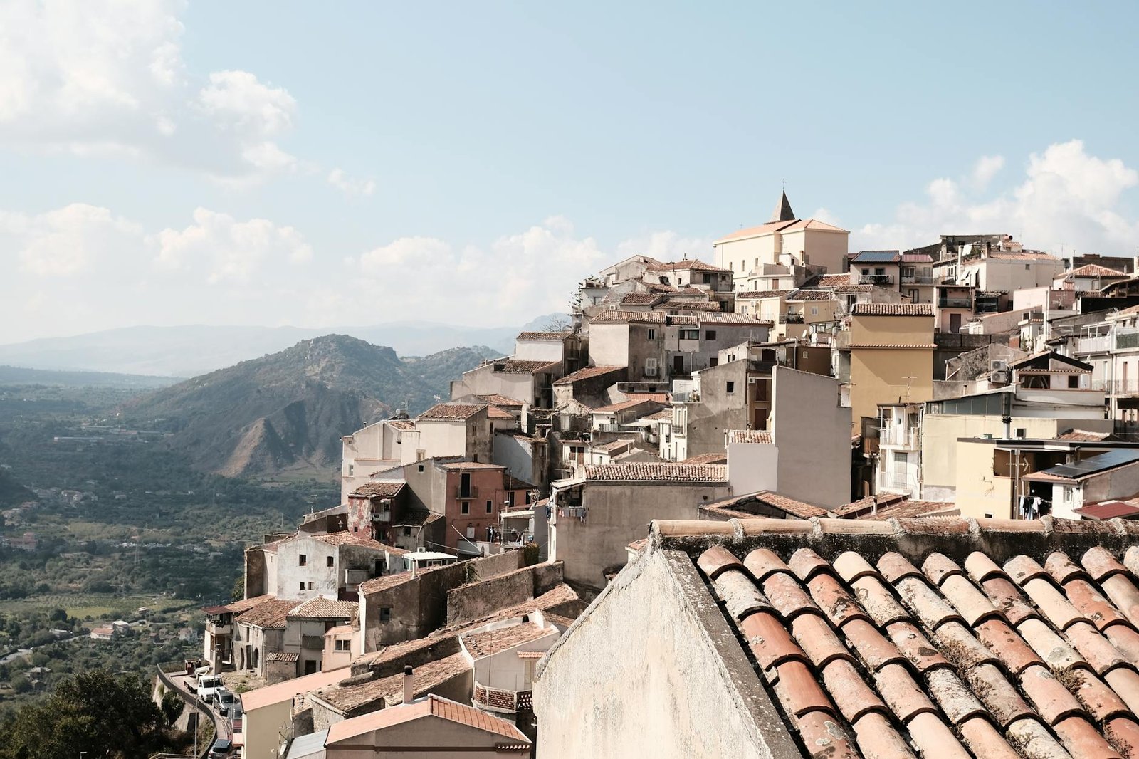 Explore the charming hillside village of Motta Camastra with its rustic architecture in Sicily, Italy.